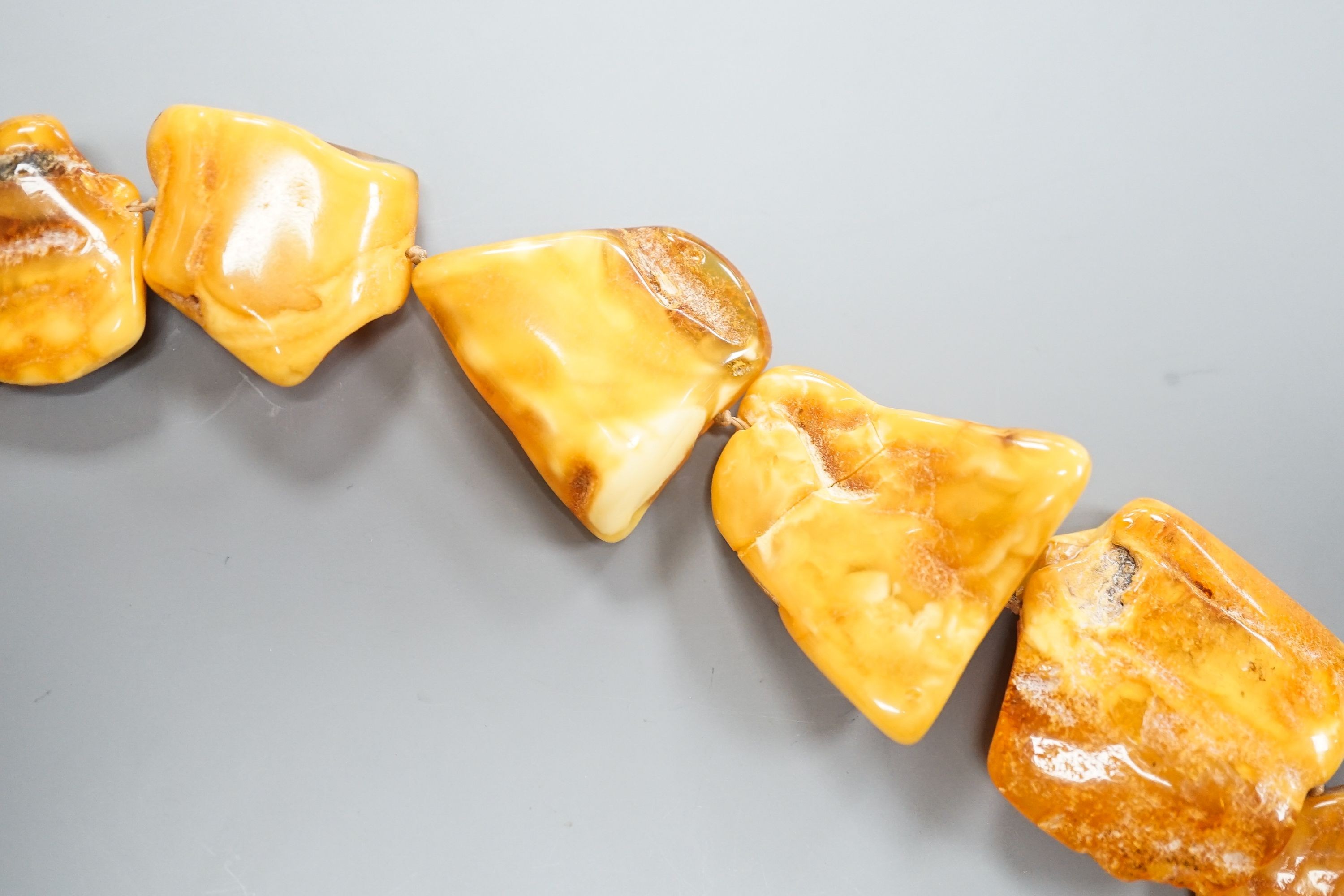 A graduated amber pebble necklace, 56cm gross weight 79 grams, (a.f.).